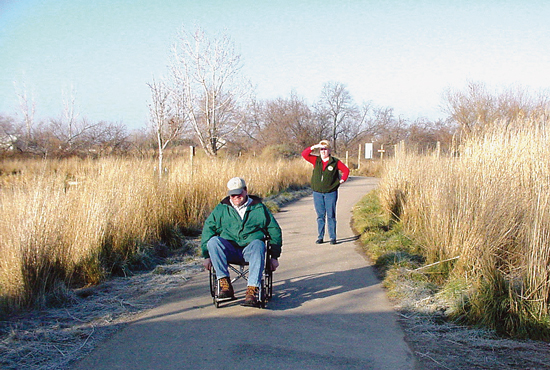 Person in wheelchair enjoys outdoor trail